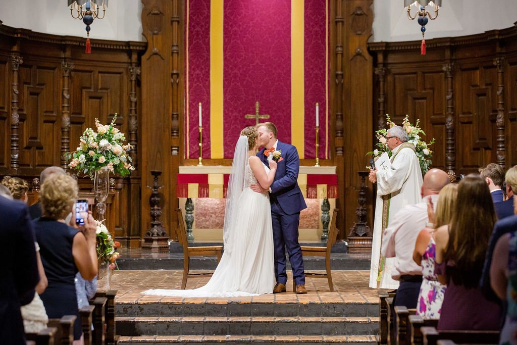 couple kissing in a catholic church at the altar