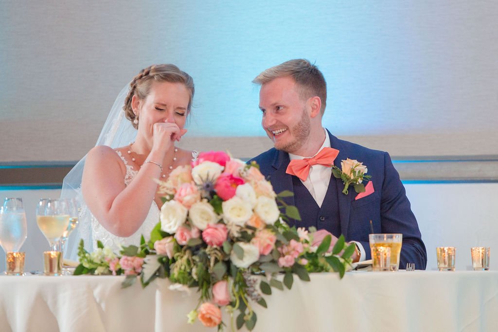 couple laughing at toast at a wedding